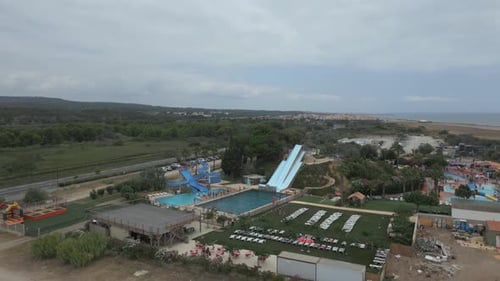 Approaching water park with swimming pool and slides