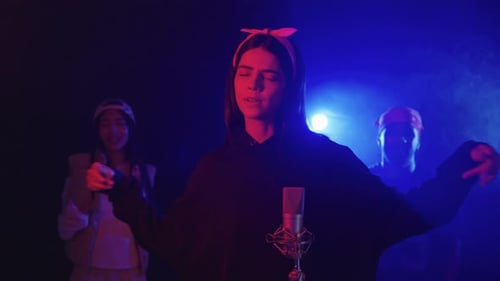Young Singer Performing with Backup Dancers in Slow Motion