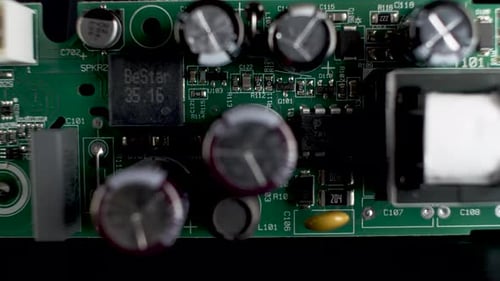 Close Up View Of Green PCB With Transistors And Chips. Dolly Left