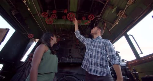 Couple exploring vintage santa fe train with conductor inside wichita Kansas