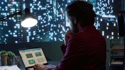 Young Adult Working Late in Bright Urban Office