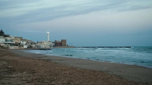 Lighthouse Flashing Over a Big Beach in Sicily Coast