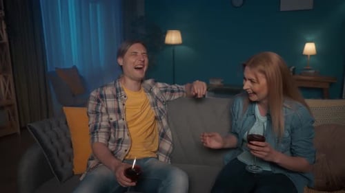 Friends Chatting and Laughing at Home With Wine