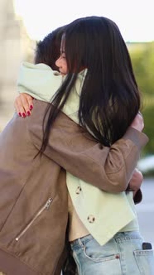 Smiling Couple Embracing in City Street