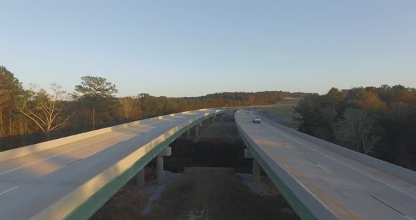 Cars driving on rural two lane road bridge over small river., Vehicles ...