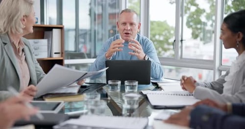 Professionals Meeting at Conference Table in Modern Office