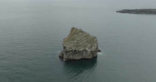Aerial view of a rock in the sea, Iceland.