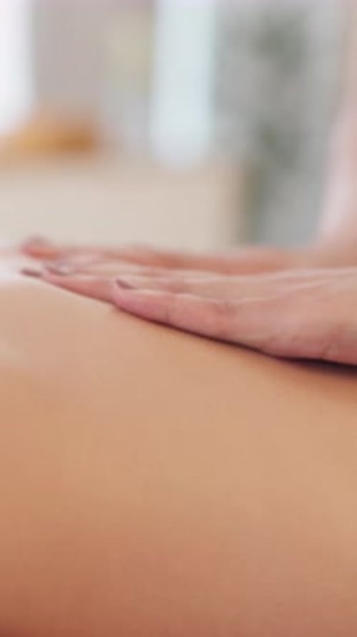Woman receiving relaxing shoulder massage in spa