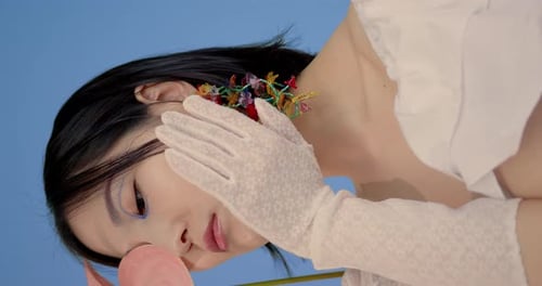 Young Woman Posing with Colorful Floral Earrings