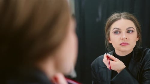 Woman Checking Her Make Up Made with Eye Liner