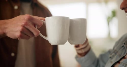 Friends Toasting Coffee Mugs Indoors