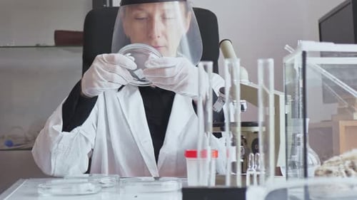 Slow Motion The Camera Moves From Bottom to Top Adult Young Female Researcher in a White Coat and