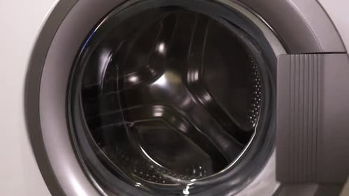 Loading Laundry into Front Loading Washing Machine