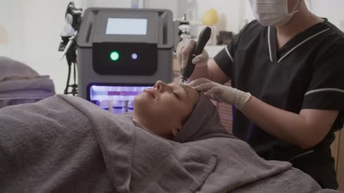 Relaxed Woman Getting Microneedling Treatment at Clinic
