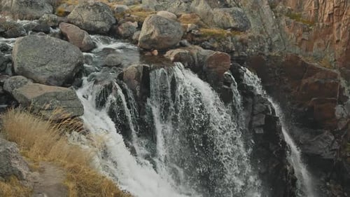 Clear River Water Flowing From the Cold Northern Rivers Forms a Small Waterfall in the Heart of the
