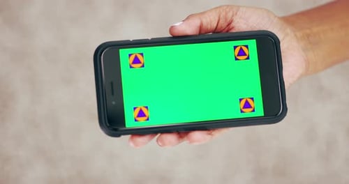 4k video footage of an unrecognizable woman holding a mobile phone with a green screen