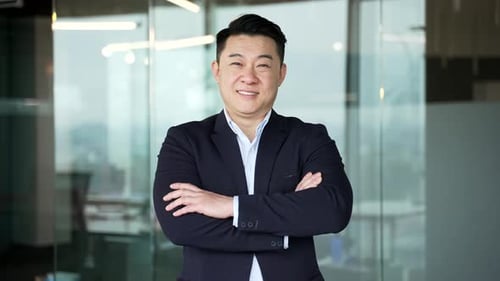 Smiling Man in Suit Poses in Office