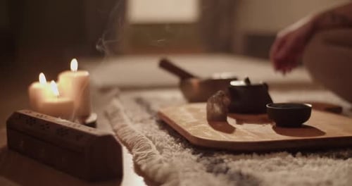 Incense and Tea Near Meditating Woman