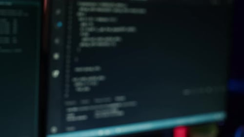 Extreme Close Up of Software Interface on PC Screens Showing Lines of Code