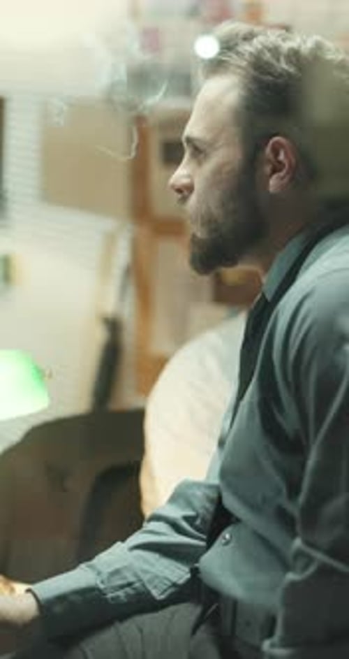 Investigation, smoking and thinking with detective man in office for review of clues or leads