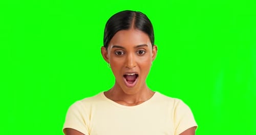 Indian woman, shock and wow face by green screen for hearing secret, info and news by background
