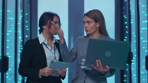 Women Discuss Technology in Modern Server Room