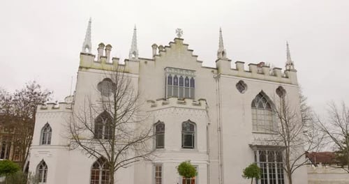 White Gothic Revival architecture of Strawberry Hill House in London on a cloudy day, exterior shot