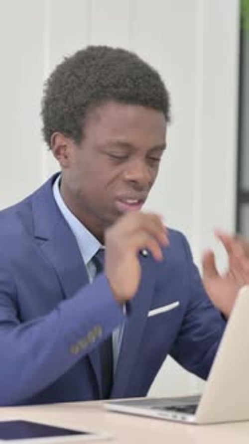 Young Man in Suit Working at Laptop