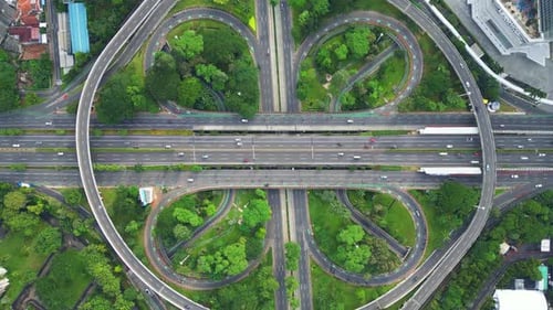 A freeway with a large bridge over it and a city in the background