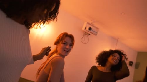 Happy Friends Grooving to Music While Enjoying Weekend Party in Living Room at Home