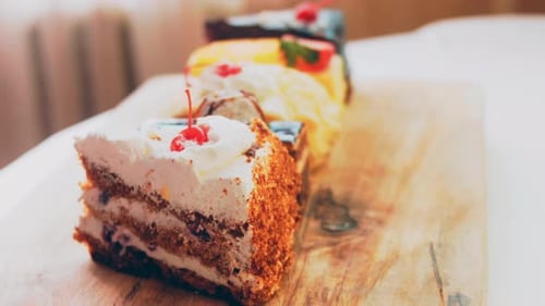 Delicious Assorted Cakes on Wooden Board