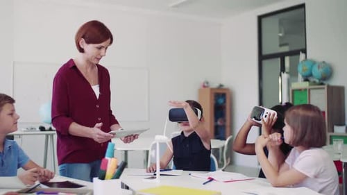 Children Using Virtual Reality Headsets in Classroom