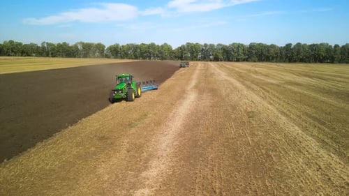 Tractors plowing the field in Ukraine
