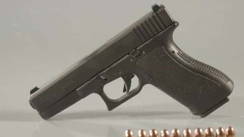 Dolly out from 9mm handgun, revealing ammunition