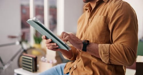 Man Uses Tablet Indoors During the Daytime