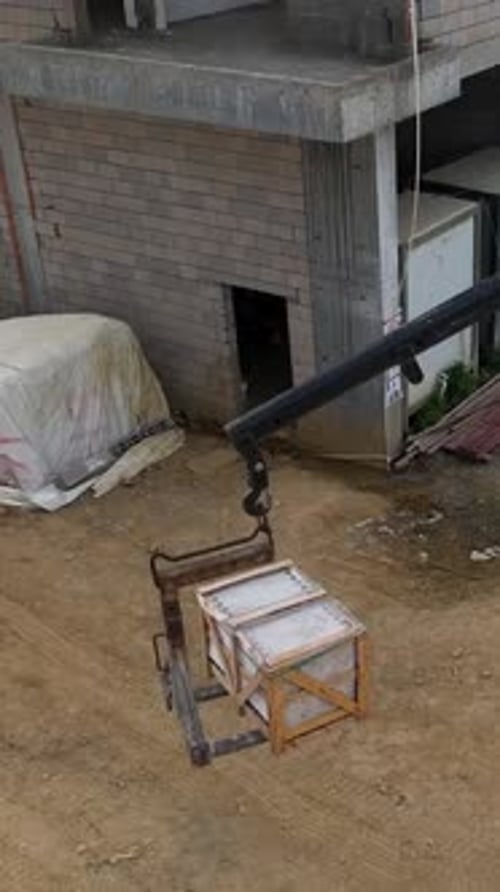 Vertical Video Aerial Construction Action Crane Unloading Builders Making Progress