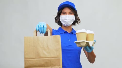 Health Protection, Safety And Pandemic Concept - Delivery Woman Or Saleswoman In Face Mask And Gl...