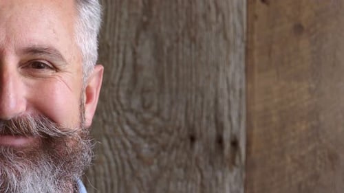 Smiling Man's Face with Gray Hair Close-Up