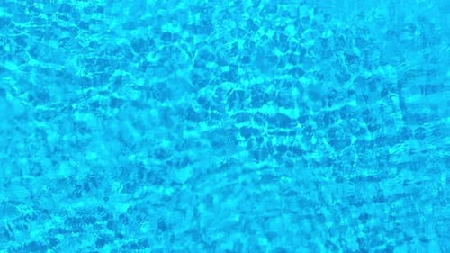 Blue Water in the Swimming Pool with Light Reflections