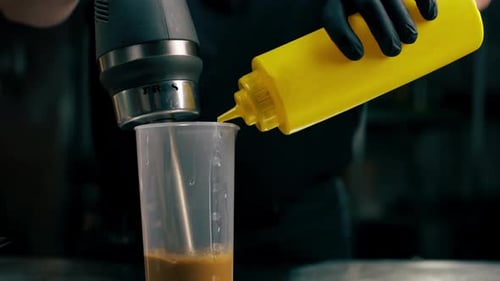Adding Sauce to Immersion Blender in Commercial Kitchen