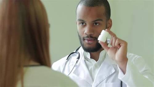 Doctor Explaining Medication to Patient in Clinic