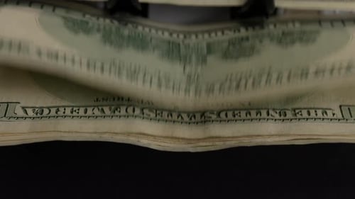 Money Counting Machine Counts Stacks of Dollar Bills