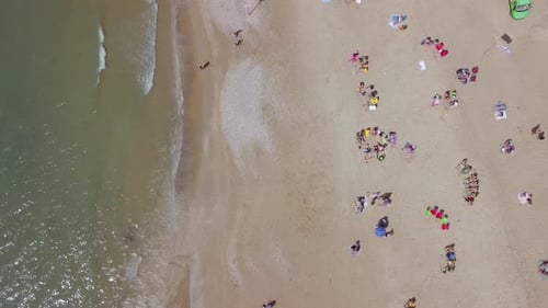 Mediterranean beach during summer with people in the water