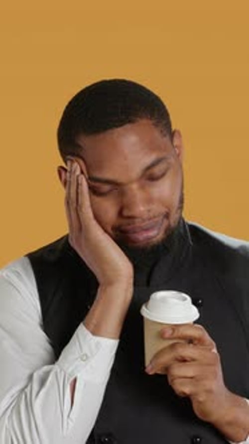 Vertical Video Tired Overworked Waiter Drinking a Coffee Cup to Relax After Long Shift