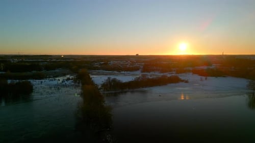 Aerial shot of winter lake at sunset