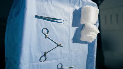 Surgical Instruments Lying on Blue Surgical Drape
