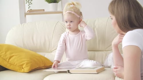 Mother and Child Read a Book Together