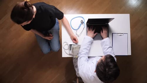 Doctor Checking Patient's Blood Pressure in Office