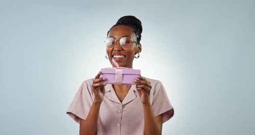 Happy black woman, face or gift box for present or birthday isolated in studio on white background