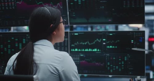 Young Lady Analyzes Complex Financial Graphs in Innovative Digital Office Space